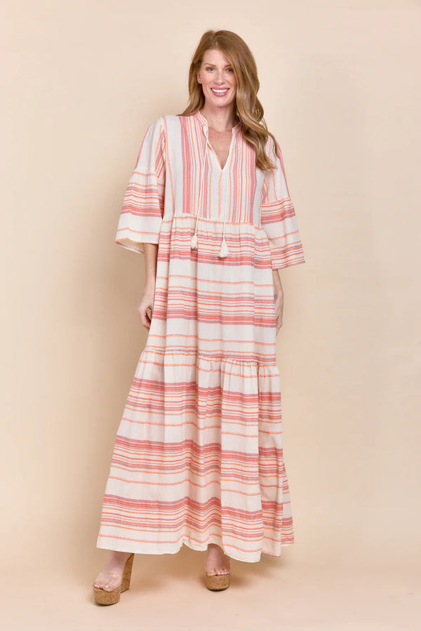Woman wearing flowy 3/4 sleeve maxi dress with pink stripes all over