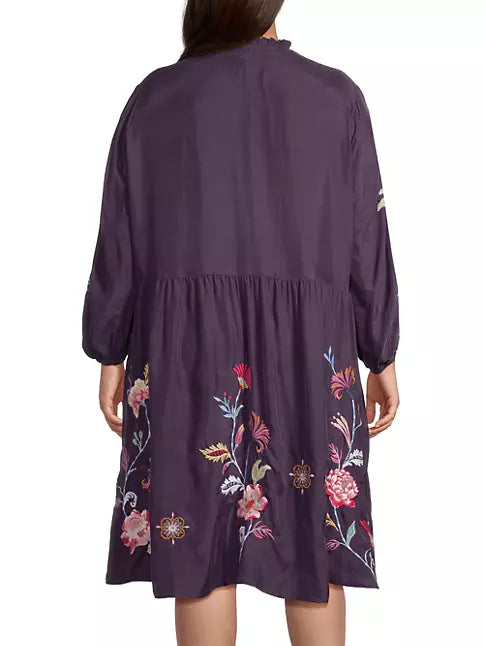 Woman wearing swing silhouette and single-tiered skirt with floral embroidery and tassel accents complete this midi-length look