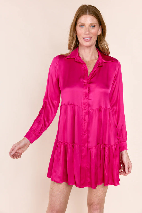 Woman wearing pink silk tiered button down dress
