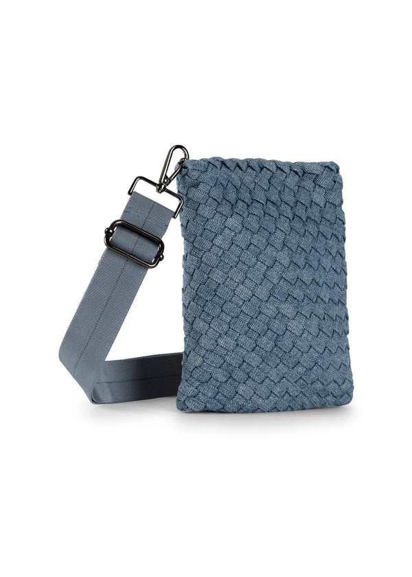 Denim cell phone bag featuring lined interior, slip pocket and magnetic closure.