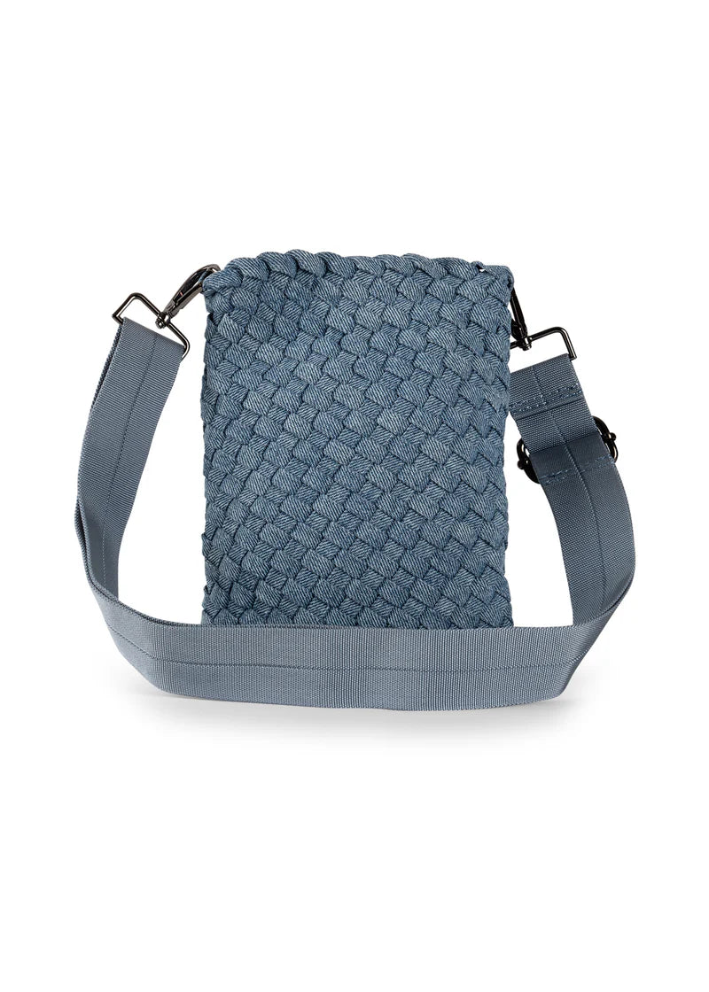 Denim cell phone bag featuring lined interior, slip pocket and magnetic closure.