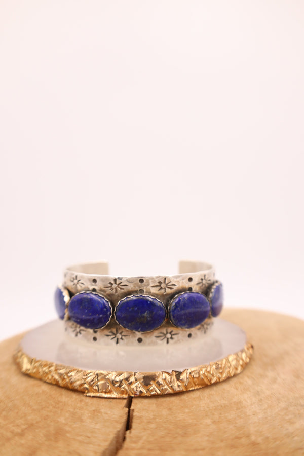 Hammered sterling silver cuff with lapis ovals in a line with star engravings throughout