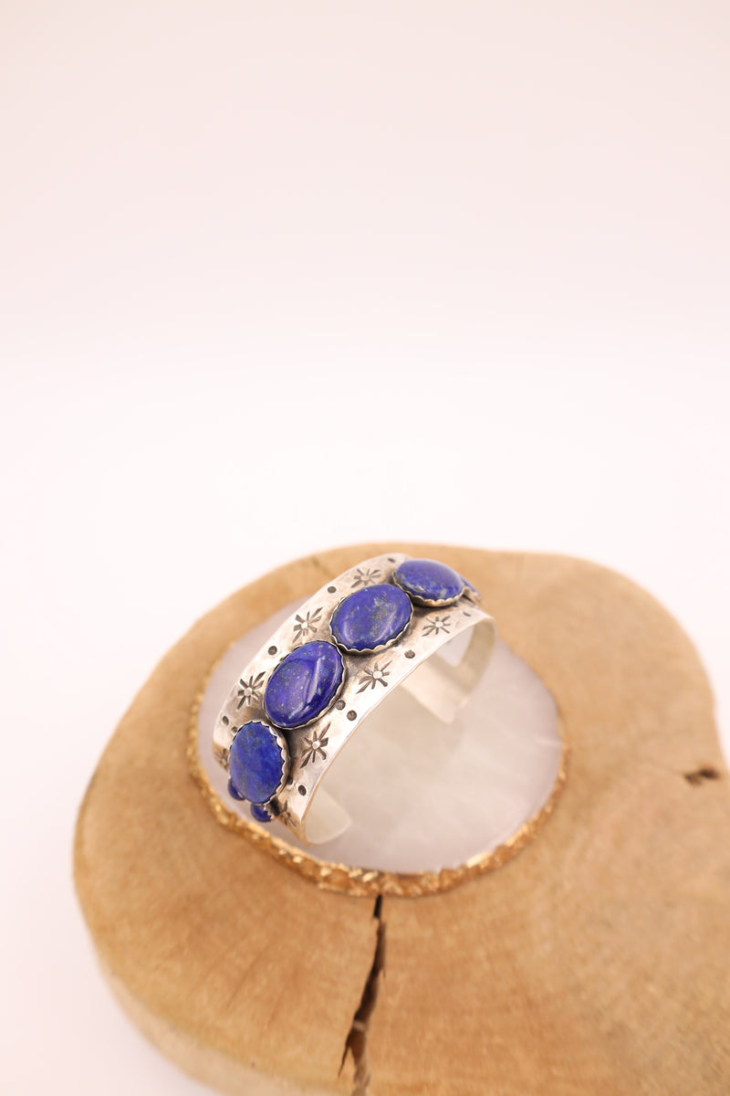 Hammered sterling silver cuff with lapis ovals in a line with star engravings throughout