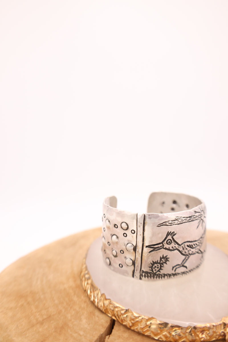 Sterling silver cuff with engraved roadrunner, cacti, sun and bubble details