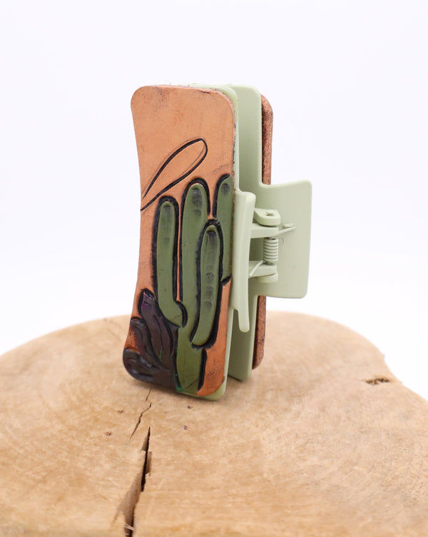 Claw clip with one side that displays armadillo and the other side has a saguaro cactus