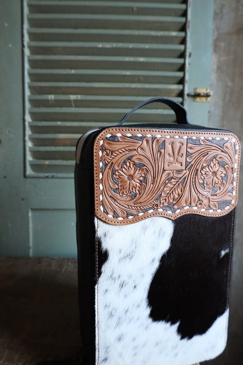 Barbie travel jewelry case with removable squash blossom tray. &nbsp;Measures 13 x 8 x 4”. Has long removable cuff holder, ring holder, and bottom compartment has squash blossom tray. Briwn leather w/black cowhide (pattern varies) with tooled leather/buckstitch laced top and black velvet interior