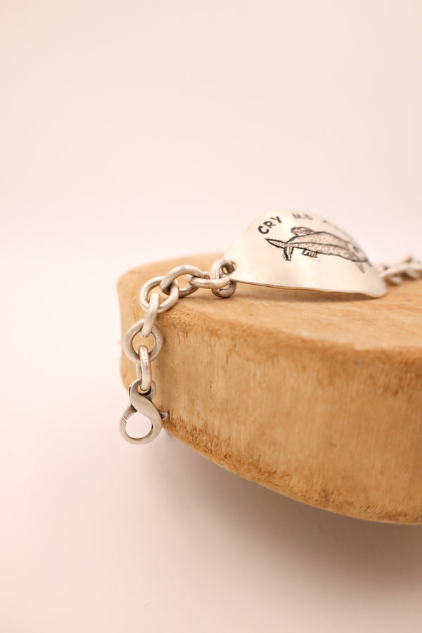 Sterling silver bracelet with center pendant that says "Cry Me A River" with chain ends