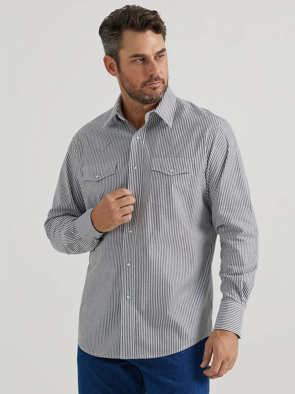 Man wearing black and white stripe pearl snap shirt with long sleeves, double breast pockets and western yokes