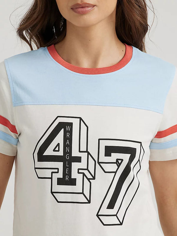Woman wearing vintage inspired tee with red white and blue colorway with number 47 in the center with wrangler in the number 4