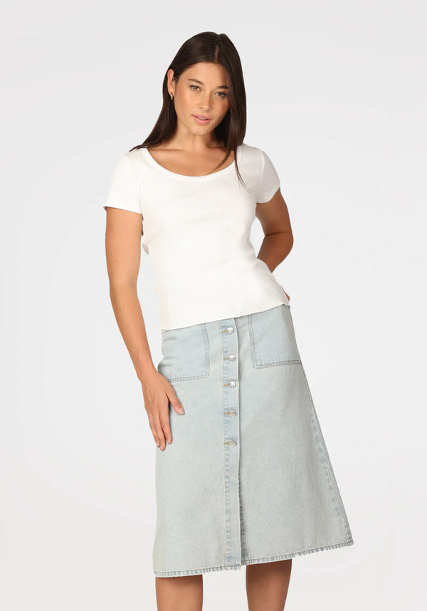 Woman wearing denim skirt with button front at knee length