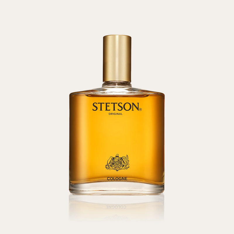 Stetson original cologne in a square container with clear appearance with see orange/yellow cologne