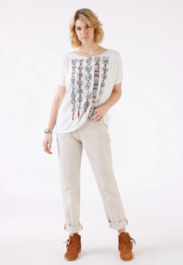 Woman wearing white short sleeve top with graphic of concho belts all over