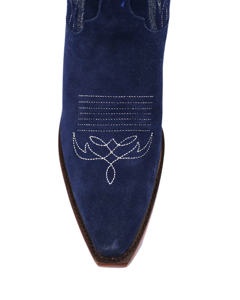 Tall indigo cowboy boots with unique stitching on the front and back