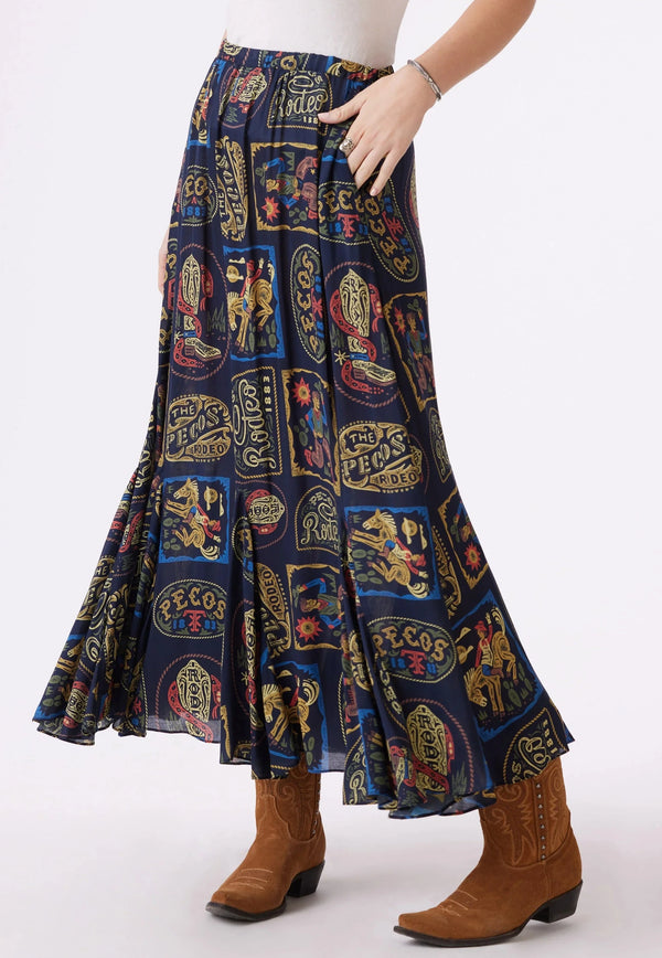 Woman wearing maxi skirt that features rodeo inspired artwork of the Pecos Rodeo