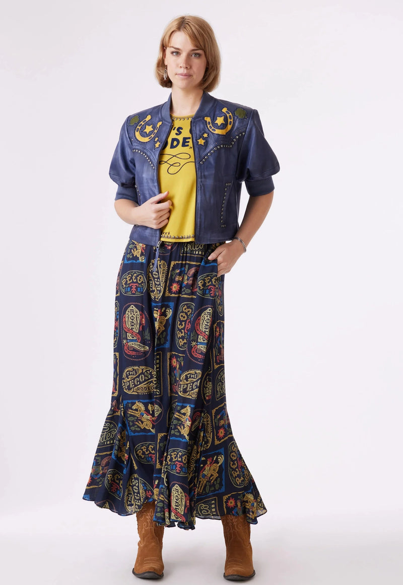 Woman wearing maxi skirt that features rodeo inspired artwork of the Pecos Rodeo