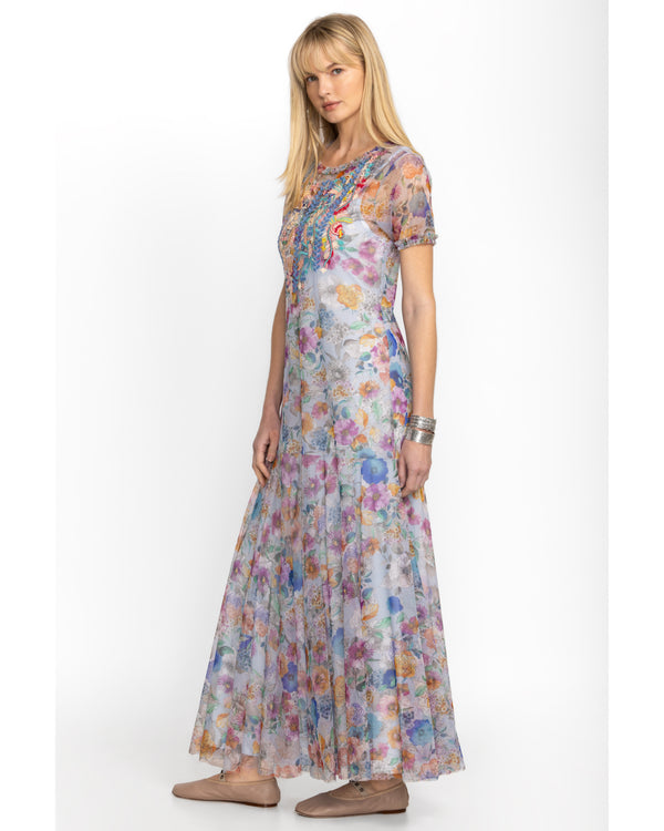 Woman wearing short sleeve maxi mesh dress with multicolor flowers all over and a slip dress underneath 