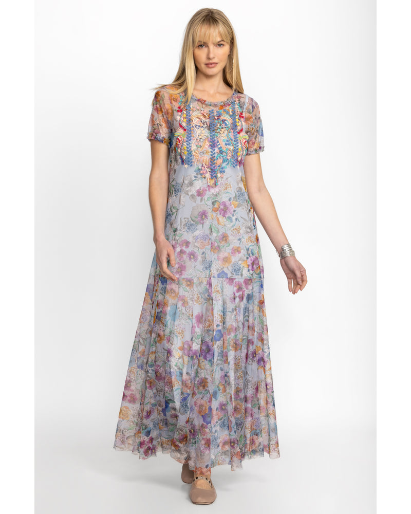 Woman wearing short sleeve maxi mesh dress with multicolor flowers all over and a slip dress underneath