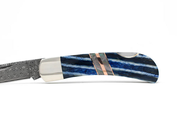 Knife with blue and white stripe handle with copper accent
