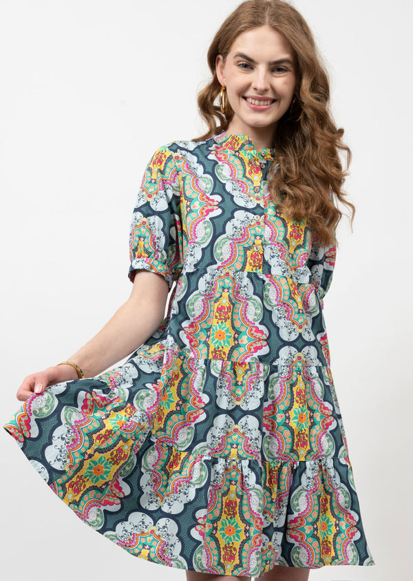 Woman wearing mini dress with multicolor pattern all over