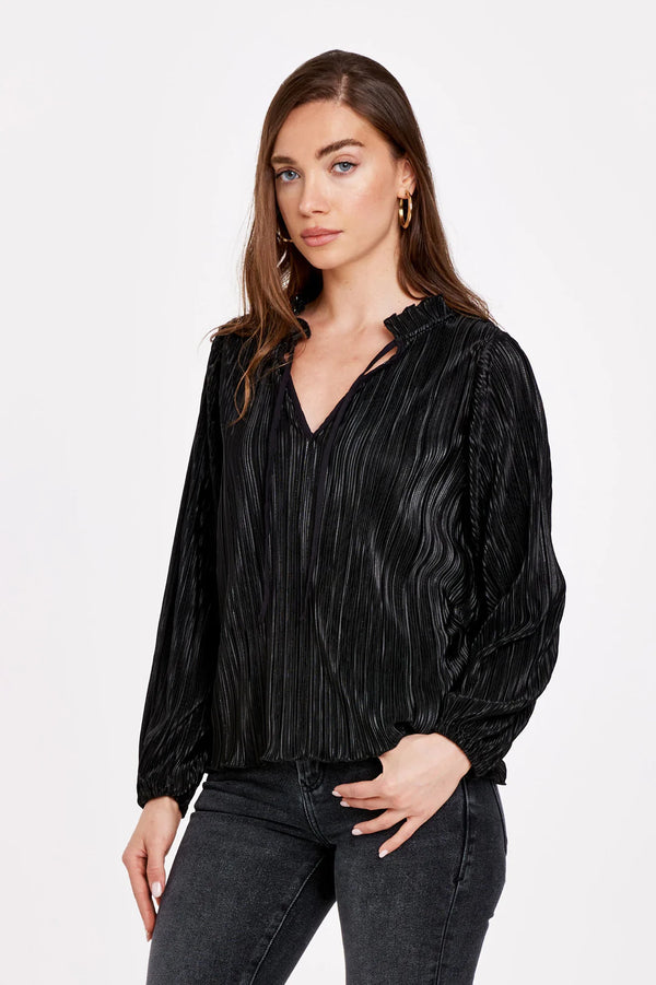 Woman wearing long sleeve v-neck with shirring & elastic cuff in pleated foil fabric.