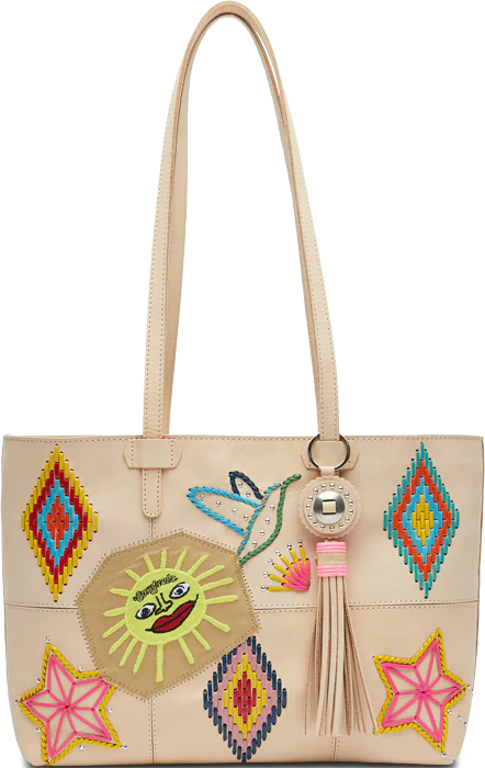 Cream leather tote purse with Aztec, bird, star sun with face and ray embroidered into the bag with concho tassel on the handle