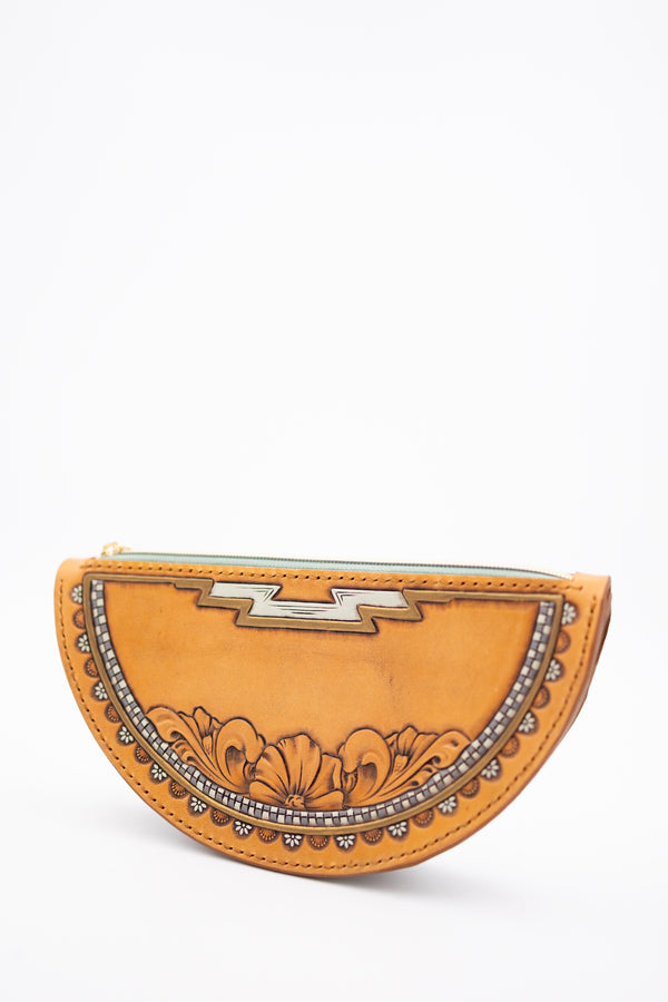 Crescent moon shaped leather handbag with hand tooled floral and detailed design