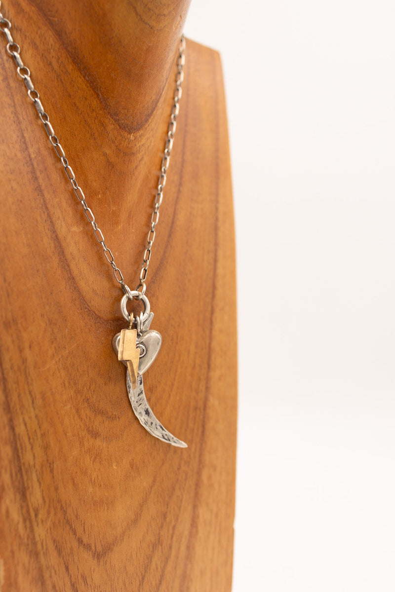 Sterling silver hammered crescent moon charm on display necklace with other display charms