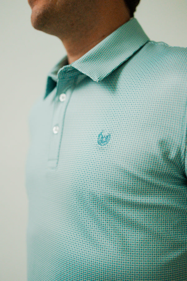 Man wearing short sleeve polo with turquoise geo pattern
