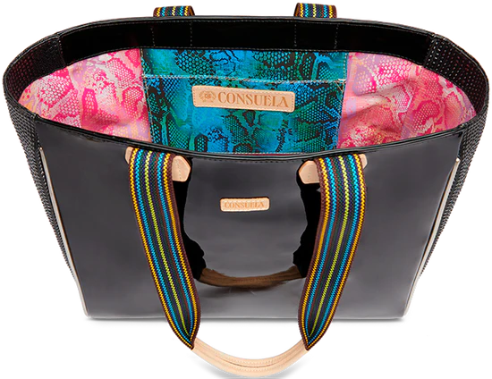 TOTE BAG WITH MULTICOLOR FLOWERS AND LEAVES ALL OVER THE FRONT AND BLACK ON THE BACK SIDE OF THE BAG. THIS PURSE HAD A MULTOCOLOR STRAP WITH TAN LEATHER IN THE CENTER AND BASE OF THE HANDLE