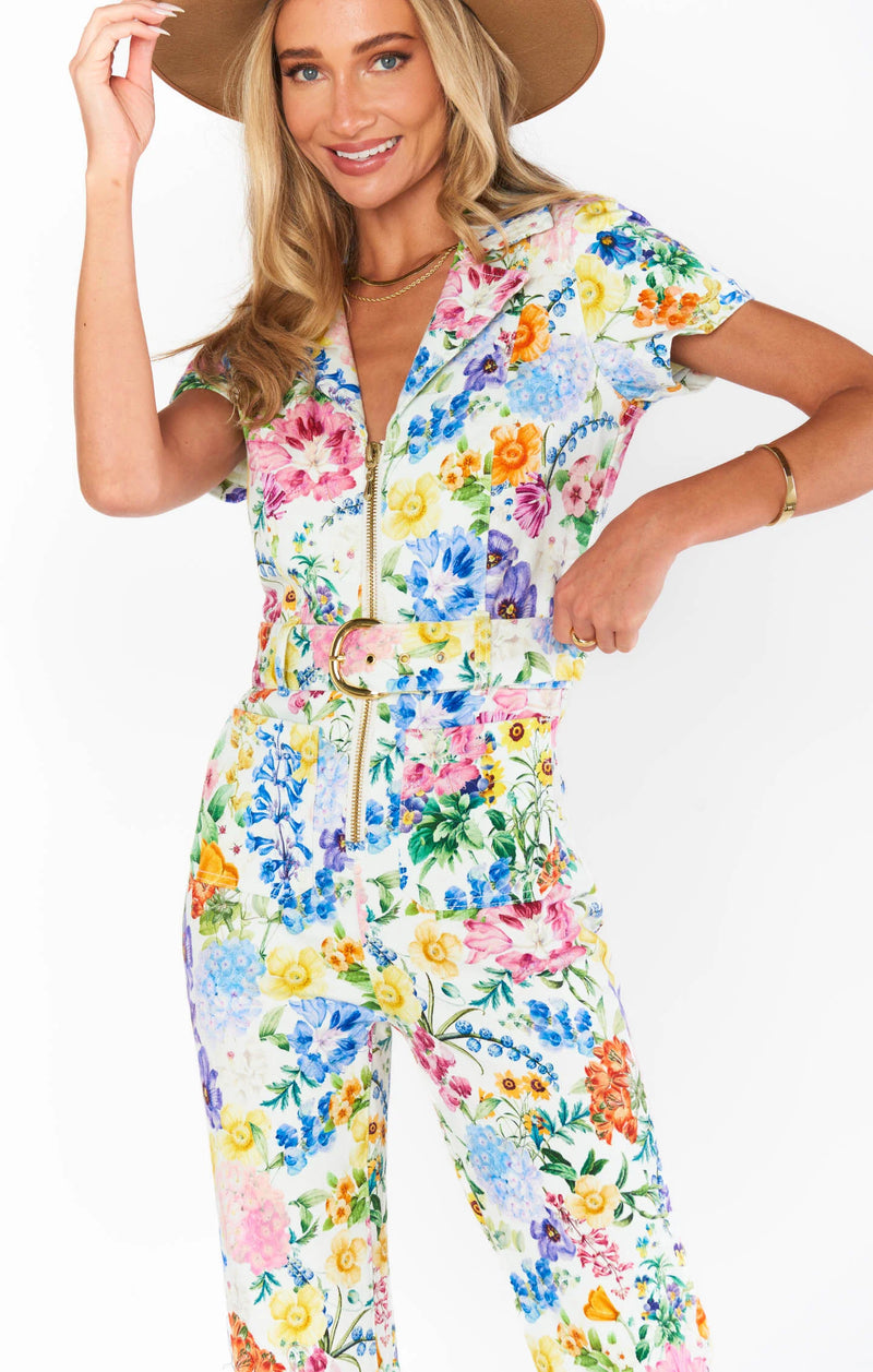 Woman wearing floral jumpsuit with matching belt