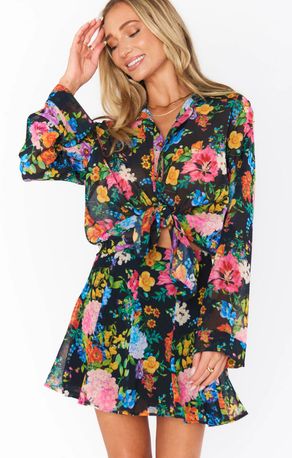 Woman wearing multi color floral with black background
