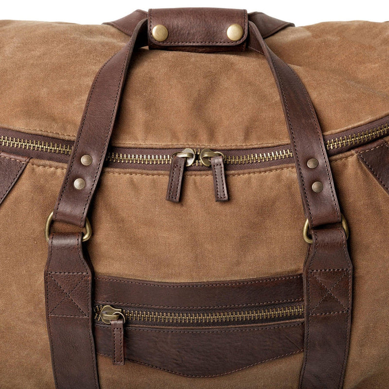 Canvas duffle bag with roller feature, zipper closures and leather handles