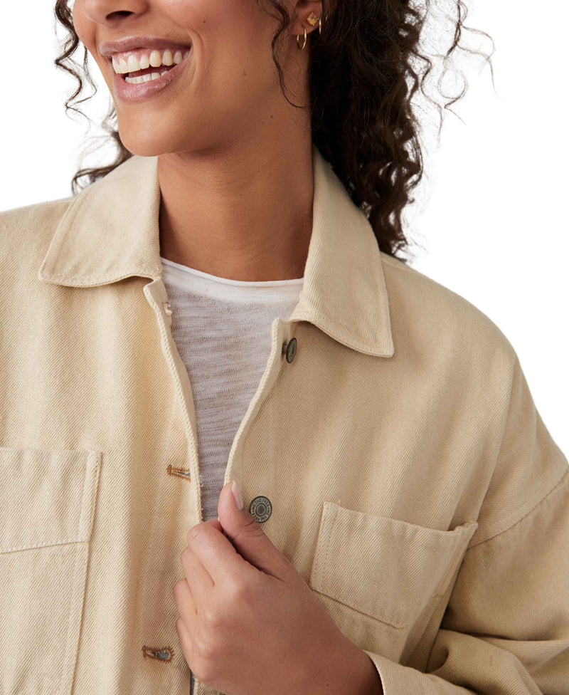 Woman wearing cream color denim jacket