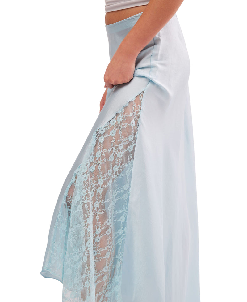 Woman wearing slinky skirt is featured in a satiny fabrication and mid-rise fit with delicate lace detailing and subtle pleating for added dimension