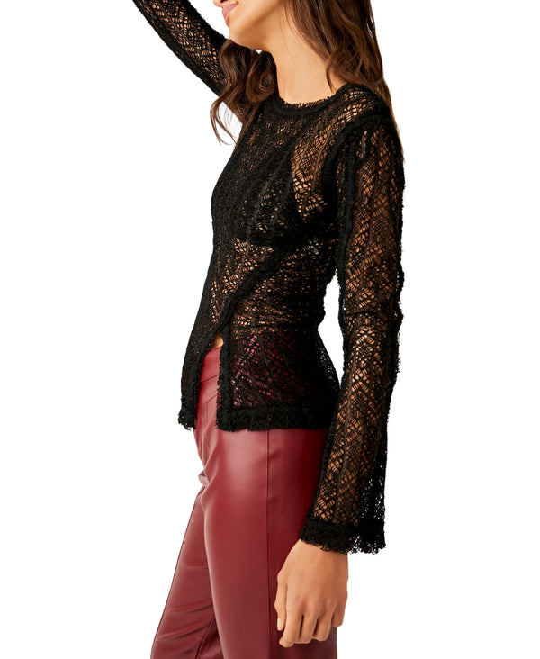 Woman wearing black see through long sleeve knit top