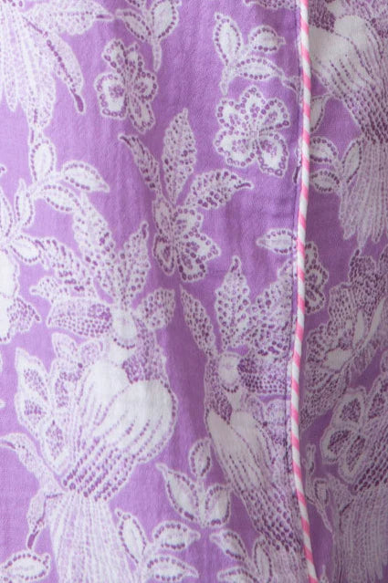 Woman wearing cami with purple and white floral pattern all over