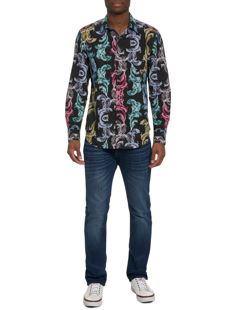 Man wearing long sleeve button down dress shirt with black background and multi color ornate pattern on top
