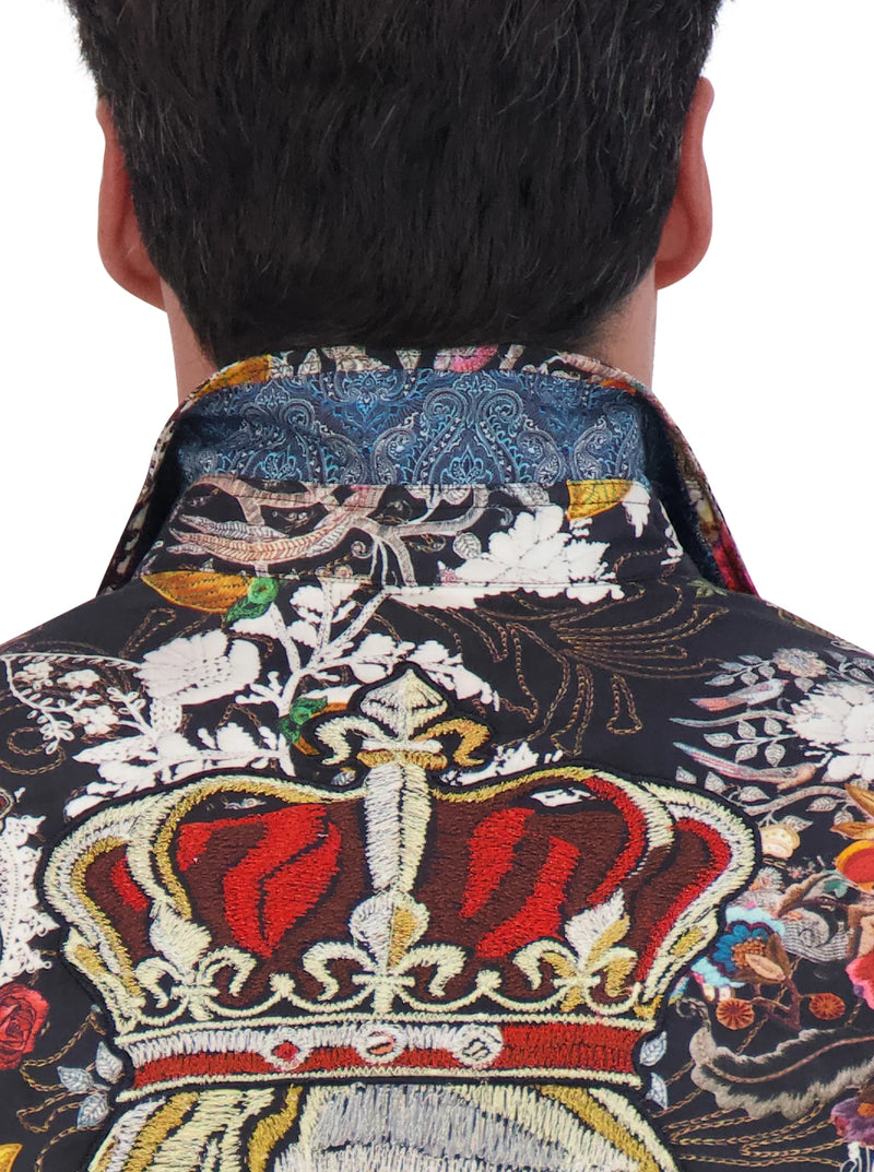 Man wearing long sleeve button down dress shirt with a variety of images throughout in multi color