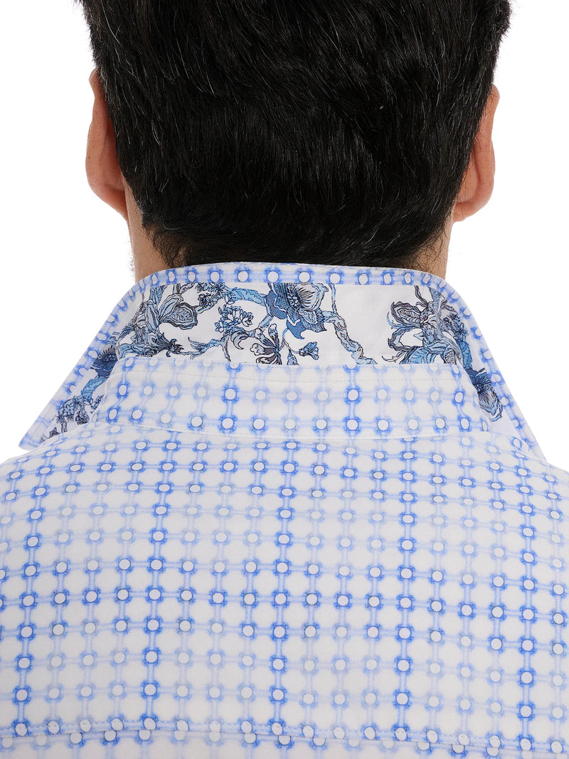 Man wearing long sleeve button down dress shirt with blue geometric square pattern