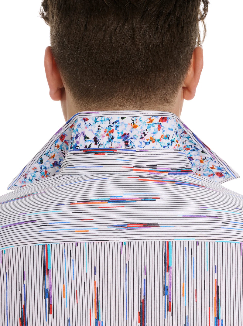 Man wearing button down long sleeve dress shirt with white background, thin stripes and multicolor streaks throughout