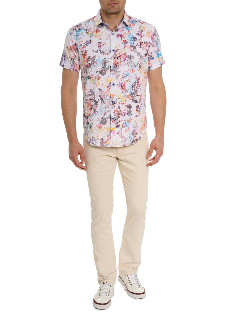 Man wearing multi color short sleeve shirt with antique images of paisley and floral pattern and button front