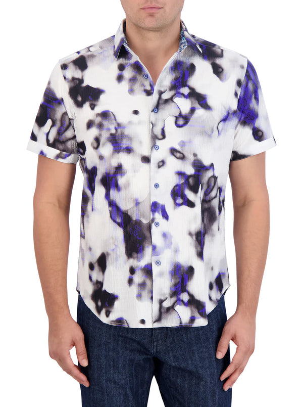 Man wearing short sleeve button up shirt with black and blue ink blot pattern