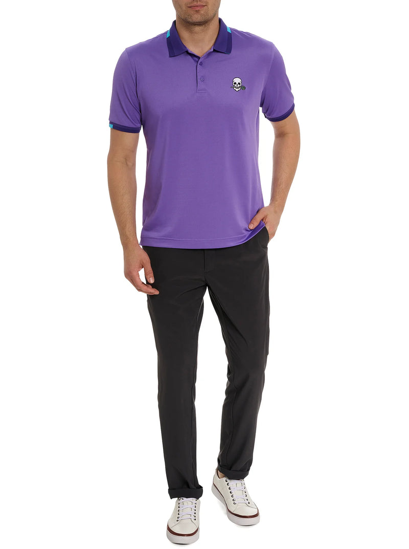Man wearing purple short sleeve polo with image of embroidered skill holding a flower in its mouth on the top right portion of the shirt