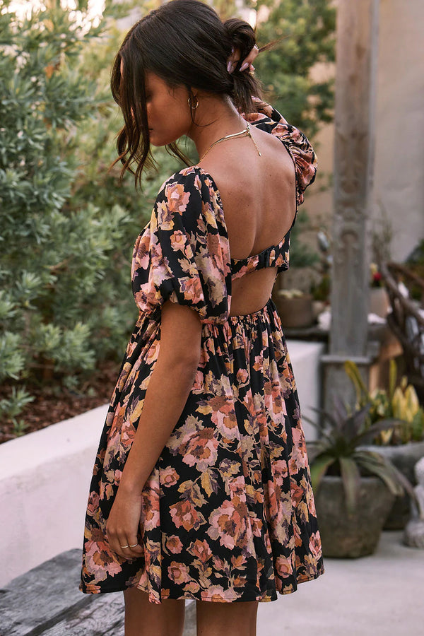 Woman wearing floral dress with cut out in the back
