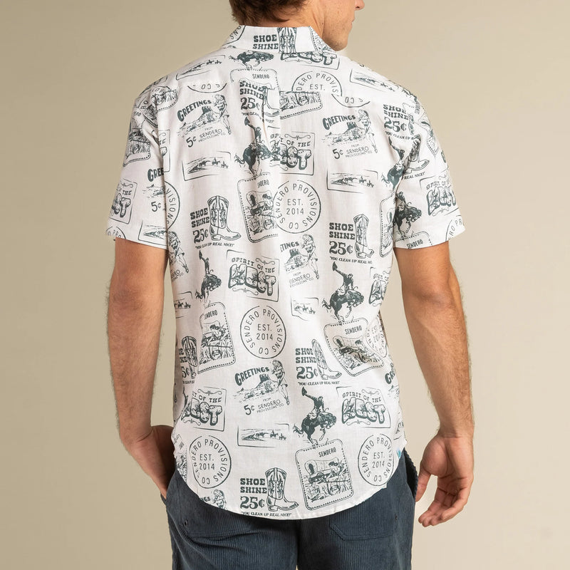 White short sleeve shirt with green icons of western postcard symbols all throughout the design of the shirt