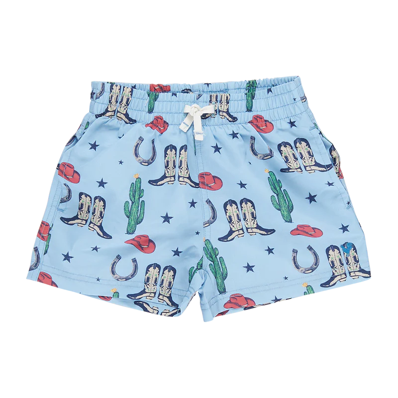 Baby boy swim trunks with blue background with images of cacti, boots, cowboy hats, horseshoes and stars all over