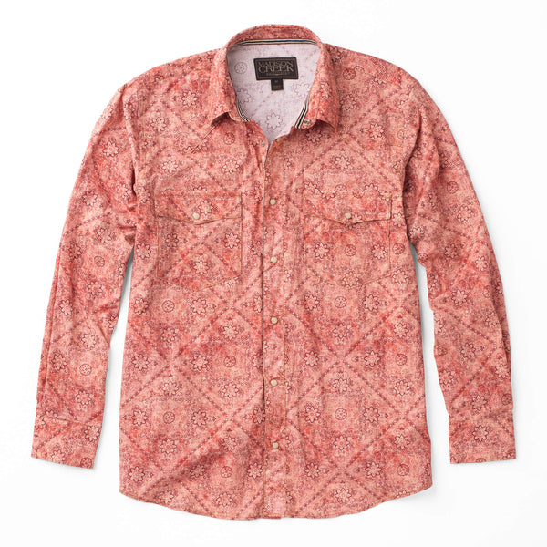 Woman's button up pearl snap long sleeve shirt with double breast pocket in a red bandana pattern