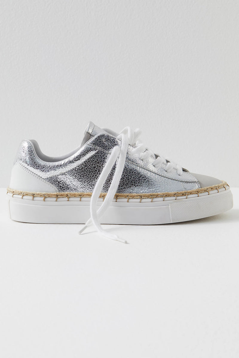 Women's metallic silver sneaker with espadrille-inspired stitching.