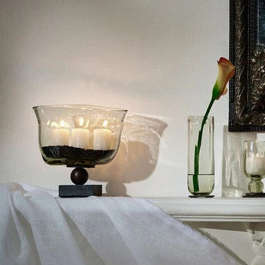 Fan-shaped vase resting atop a balin stand
