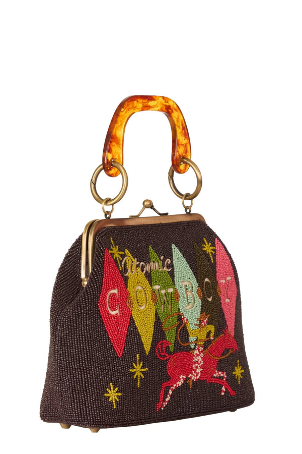 Handbag with colorful embroidery and tortoiseshell handle on a white background